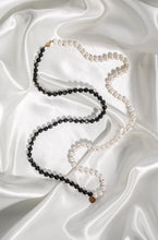 Ladda upp bild till gallerivisning, Elegant long handknotted pearl collier necklace with freshwater pearls and goldsheen obsidan. Presented on white silk fabric.