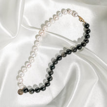 Ladda upp bild till gallerivisning, Pearl collier choker necklace presented on white silk. Handknotted pearl collier necklace with half in pearls and the other half in shimmering gold sheen obsidian gemstones. Details in 18k gold plated sterling silver.
